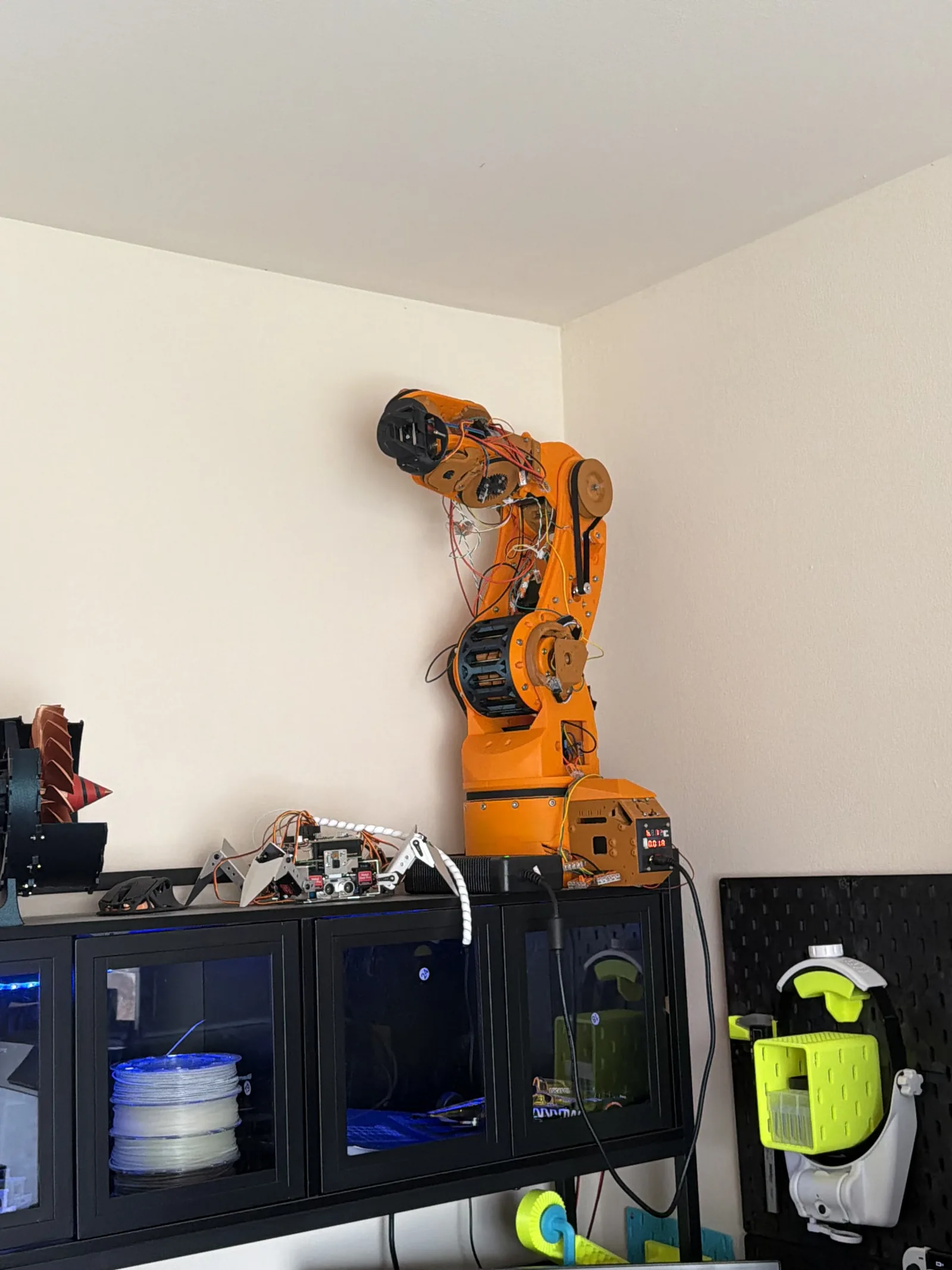The orange arm mounted above a 3D printer, fully assembled