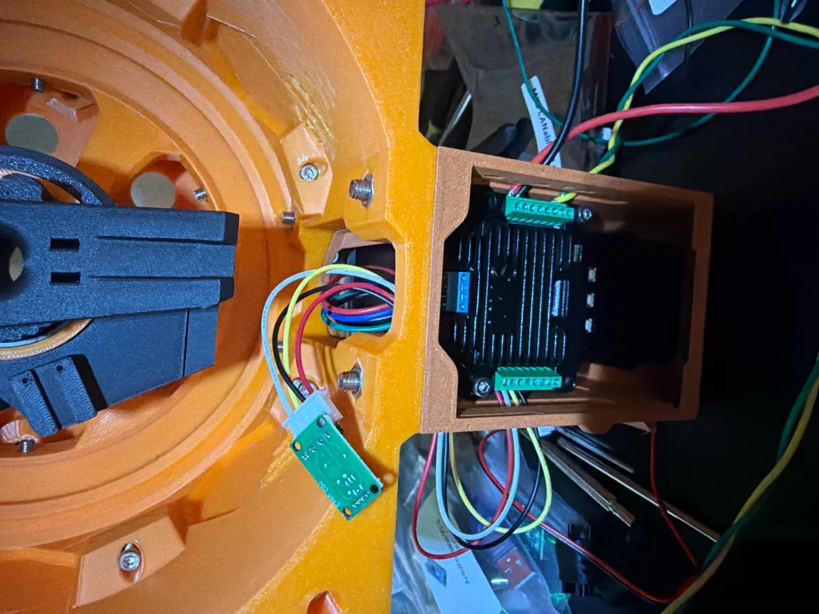 The arm's shoulder assembly opened up, showing the drive components under load