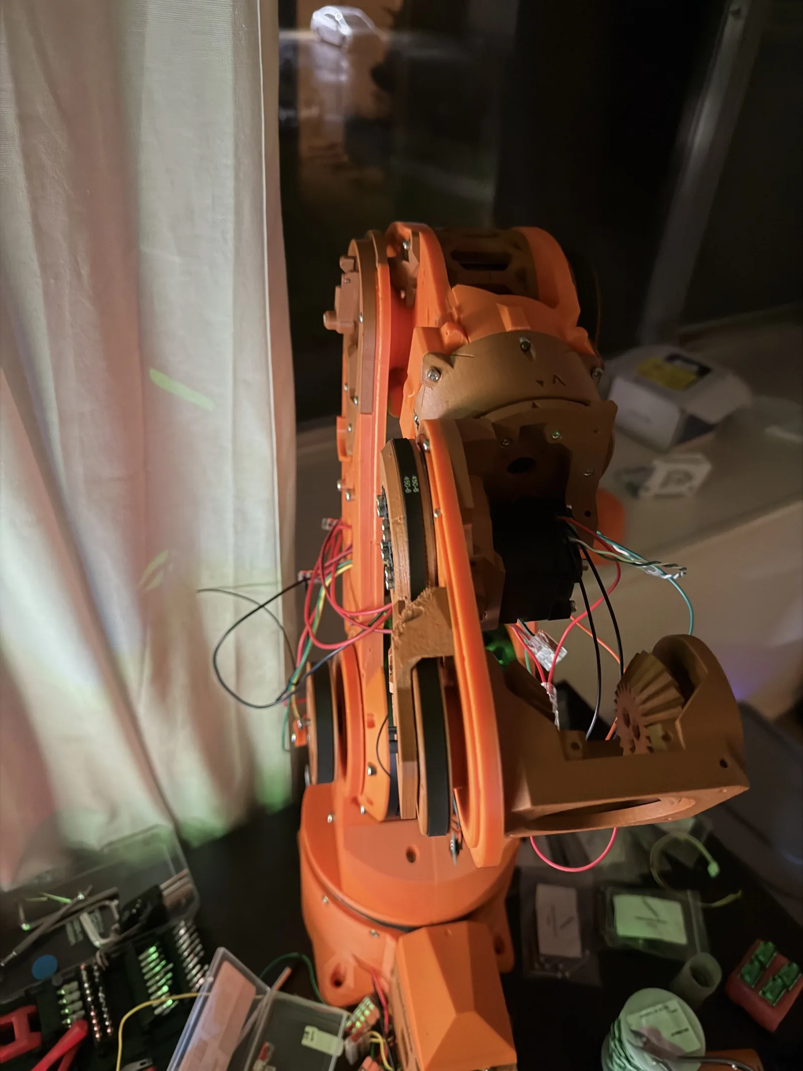 The orange arm collapsed on its side with wiring pulled taut