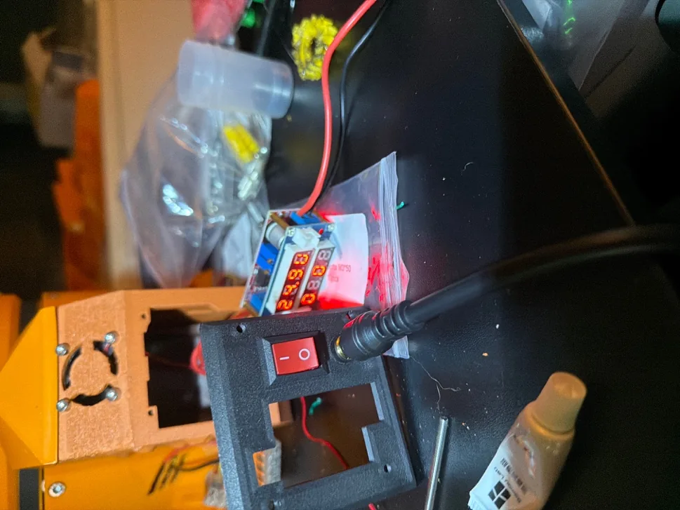 The arm base with a new power switch and barrel jack fitted during the rewire