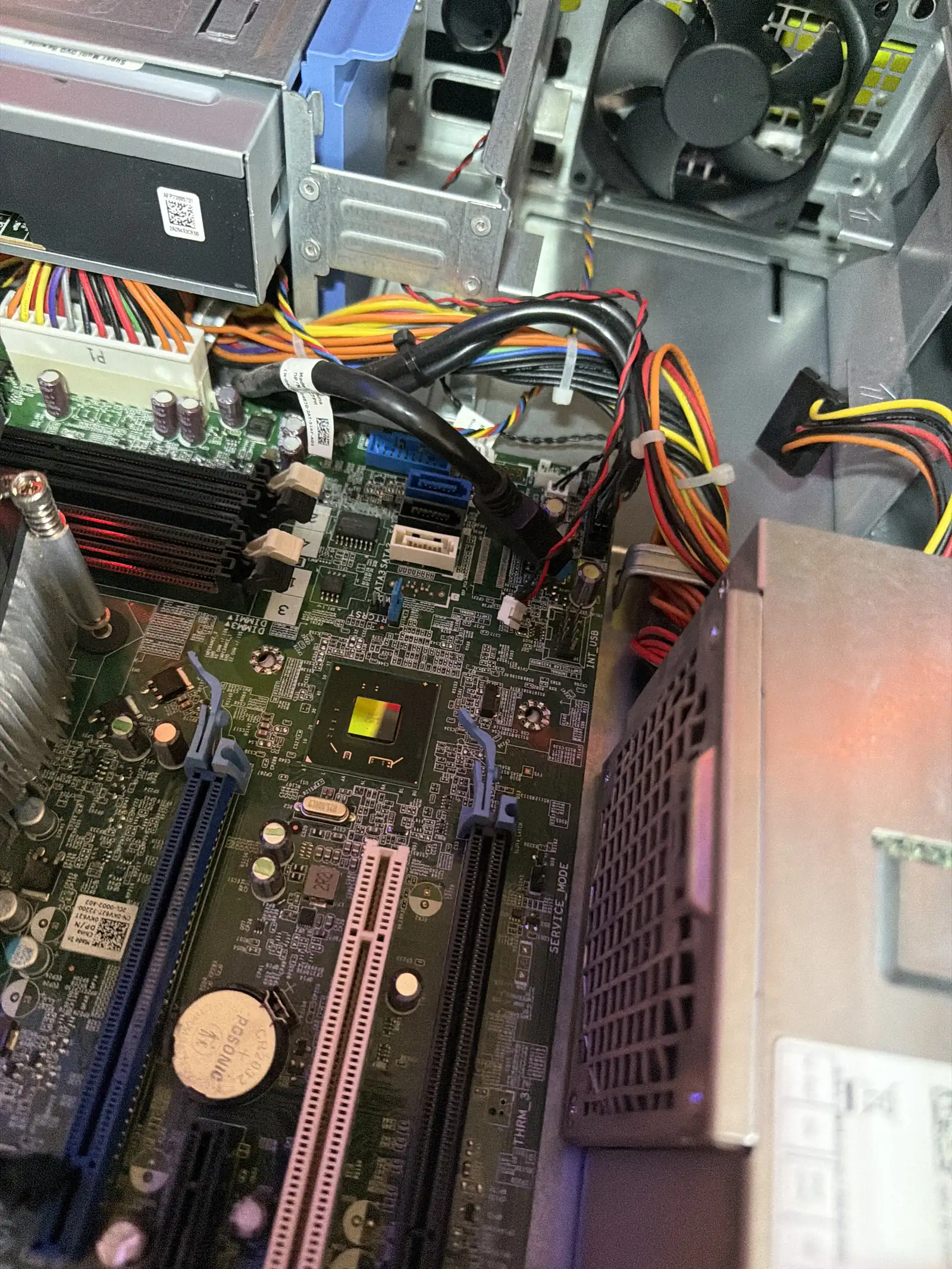 A GPU node's motherboard and power supply cabling during the cluster build