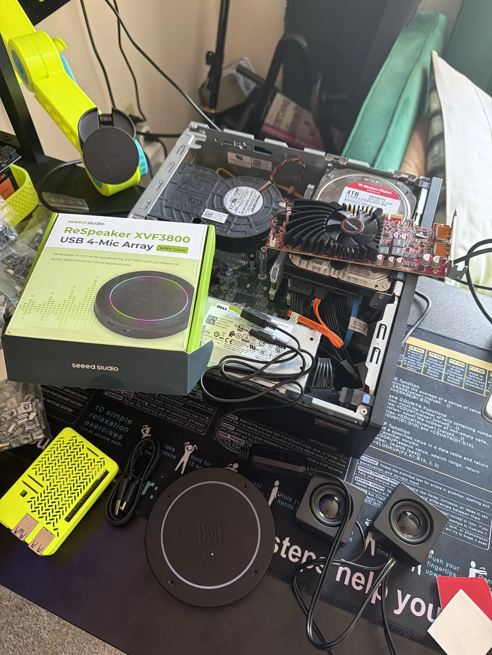 A ReSpeaker USB 4-microphone array, still boxed, beside the compute hardware it runs on